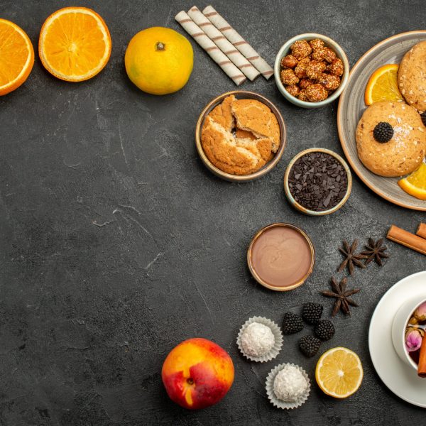 top-view-delicious-cookies-with-cup-of-tea-on-dark-2025-02-10-09-04-04-utc
